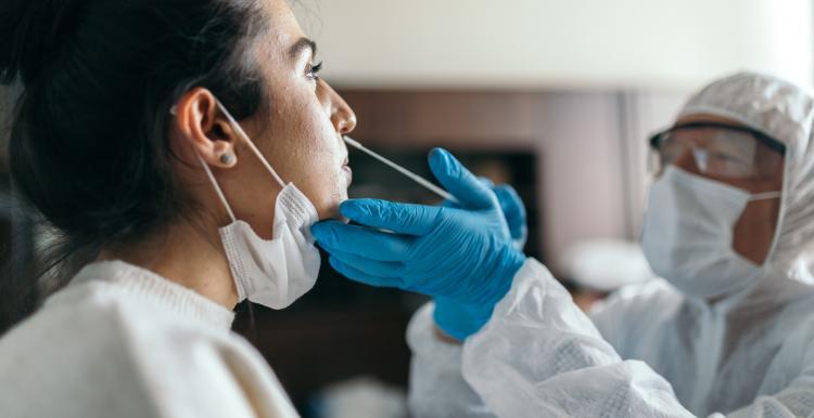 A woman having a lateral flow covid test