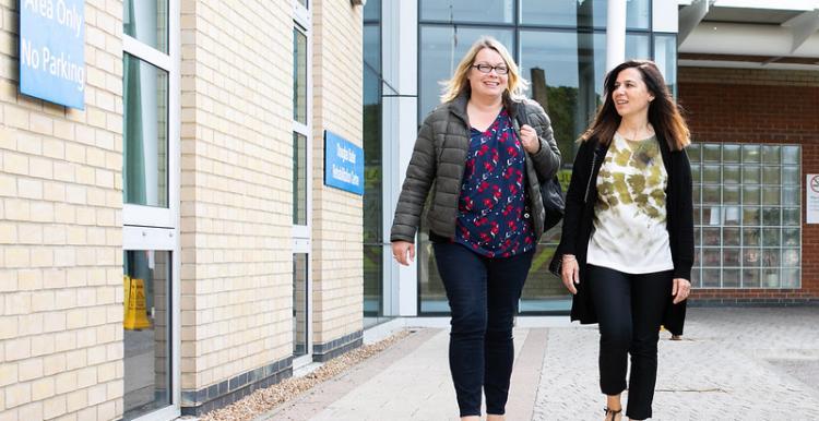 women walking outside a hospital