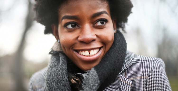person wearing a coat smiling at camera