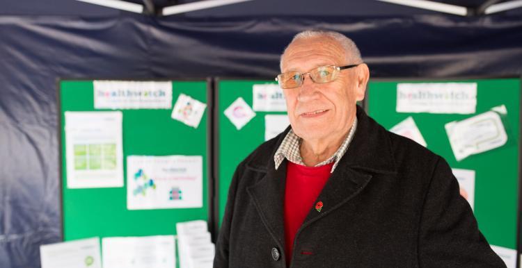 Male volunteer promoting Healthwatch at an event