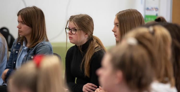 Group of young people sitting listening