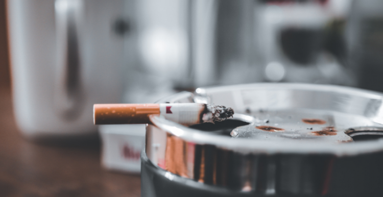 Ashtray with lit cigarette Ashtray with lit cigarette