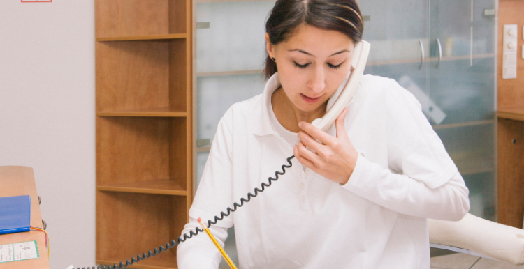 Woman at reception desk on phone