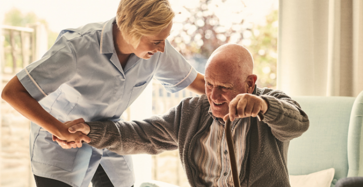 Care worker helping an older man