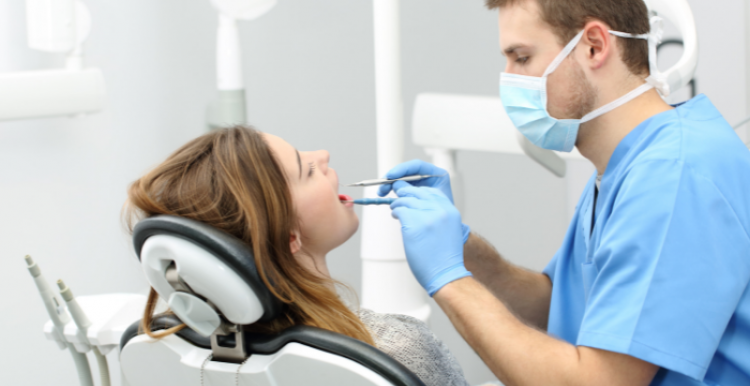 Dentist examining patients teeth