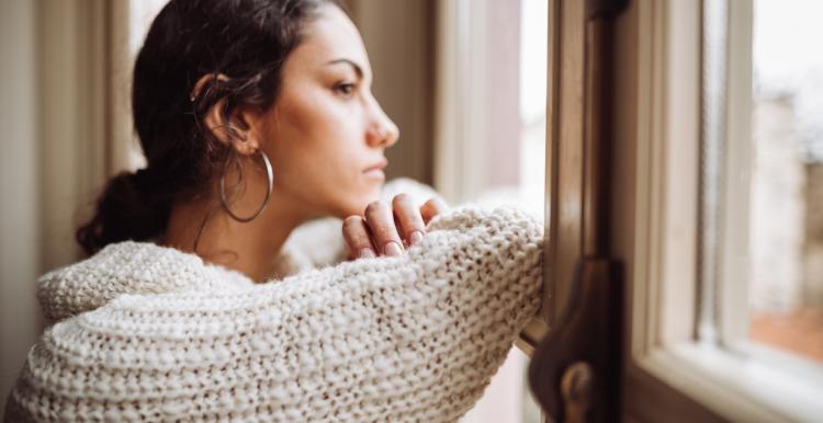 woman alone staring out the window