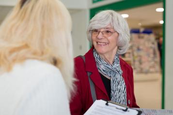 Women talking to a lady with a clipboard