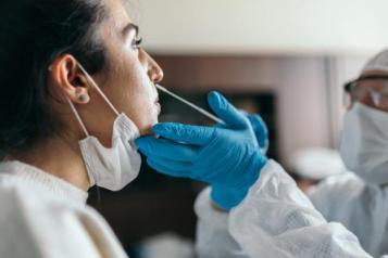 A woman having a lateral flow covid test