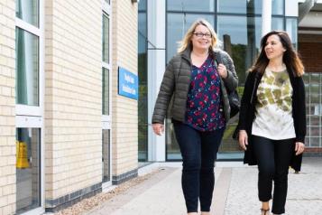 women walking outside a hospital