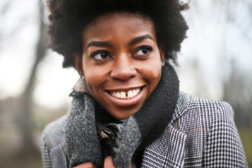person wearing a coat smiling at camera