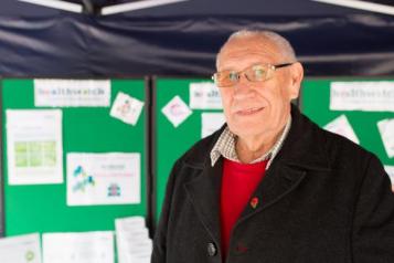 Male volunteer promoting Healthwatch at an event