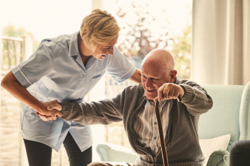 Care worker helping an older man