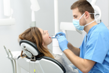 Dentist examining patients teeth