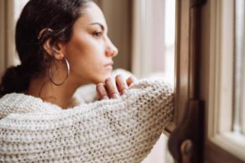 woman alone staring out the window