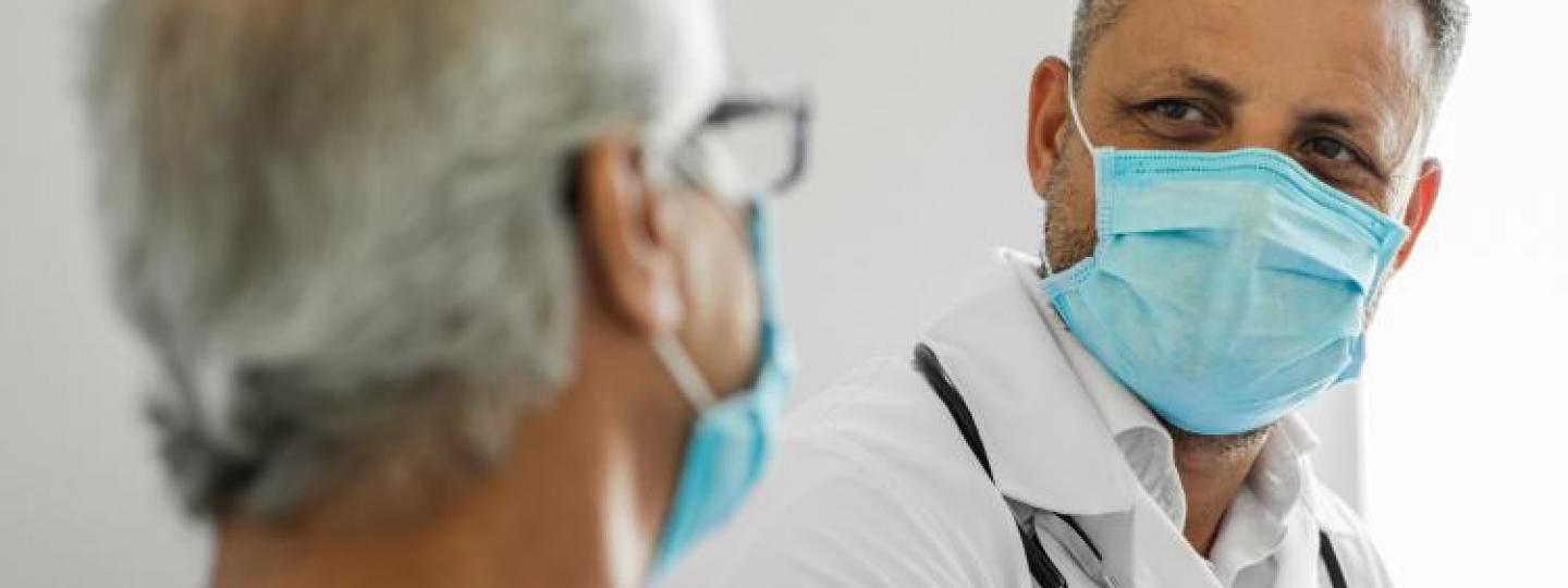 male doctor talking to a senior patient