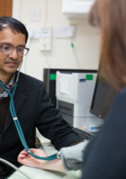 GP taking a patients blood pressure