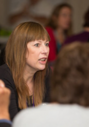 Lady talking to group